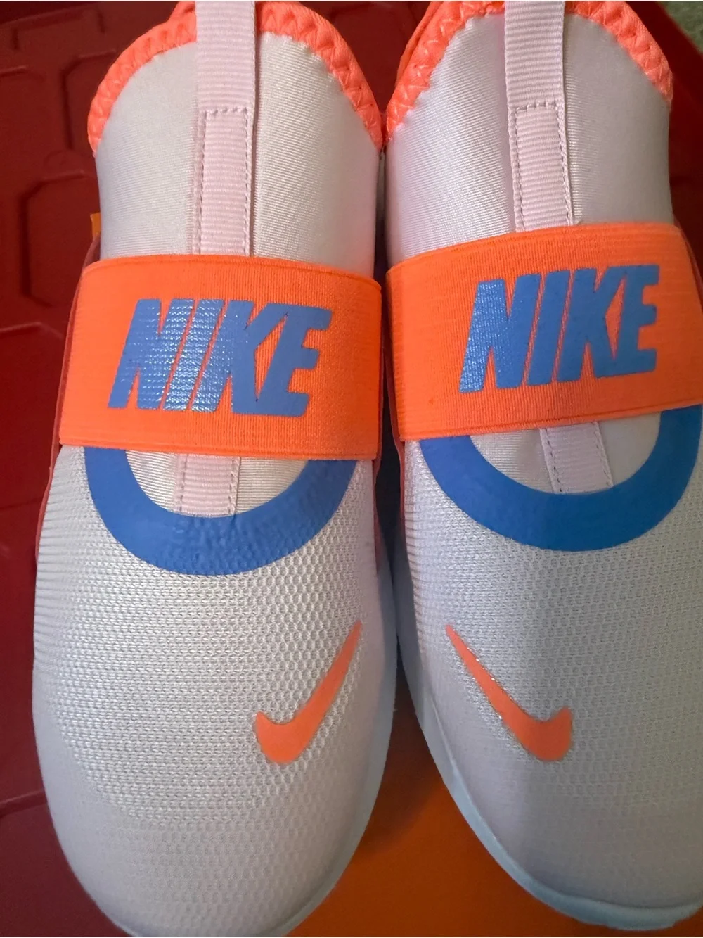 Nike Kids Slip-On Sneakers in white Orange & Purple Accents